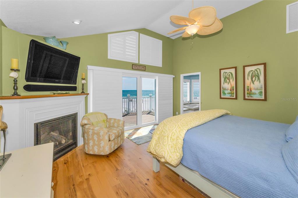 13303 Gulf Lane Madeira Beach, FL 33708 - Photo 15 of 42 a bedroom with a bed and a flat screen tv