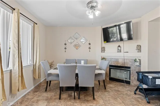 a view of a dining room with furniture and a fireplace