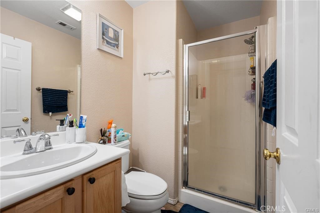 39351 Memory Drive Murrieta, CA 92563 - Photo 19 of 39 a bathroom with a granite countertop sink toilet and shower