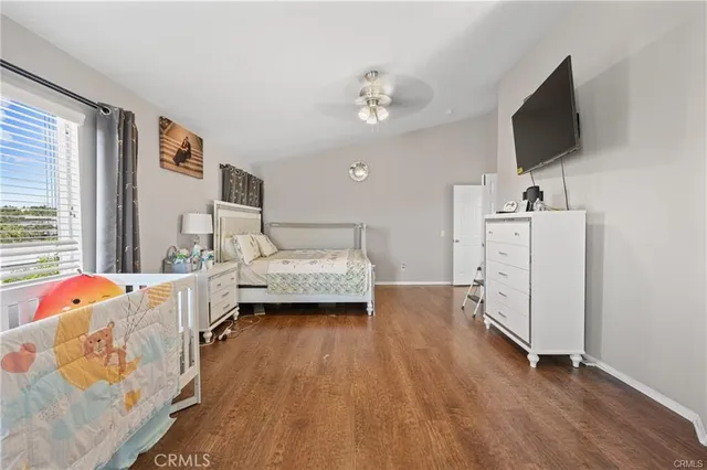 a bedroom with furniture and a flat screen tv