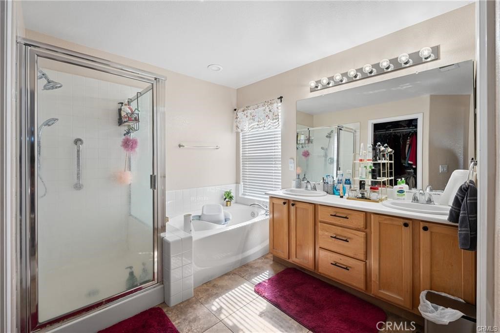 39351 Memory Drive Murrieta, CA 92563 - Photo 26 of 39 a large bathroom with a double vanity sink a mirror and a bathtub