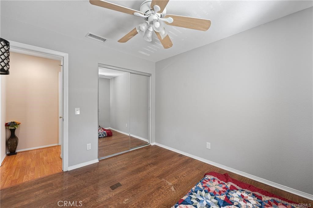 39351 Memory Drive Murrieta, CA 92563 - Photo 28 of 39 an empty room with wooden floor and fan