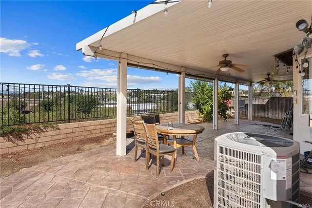 a view of a patio with table and chairs potted plants with wooden fence