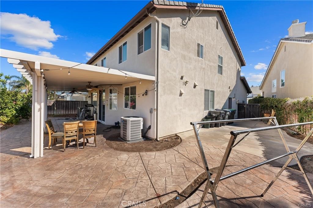 39351 Memory Drive Murrieta, CA 92563 - Photo 34 of 39 a view of a patio with table and chairs potted plants with wooden fence