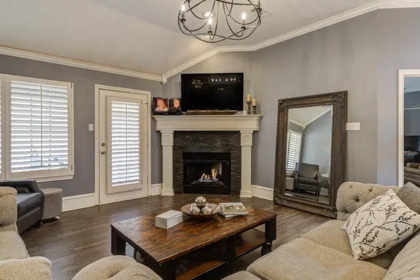 a living room with furniture a fireplace and a flat screen tv