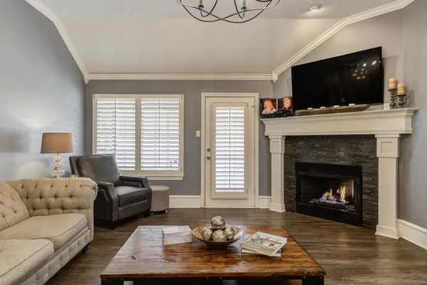a living room with furniture fireplace and flat screen tv