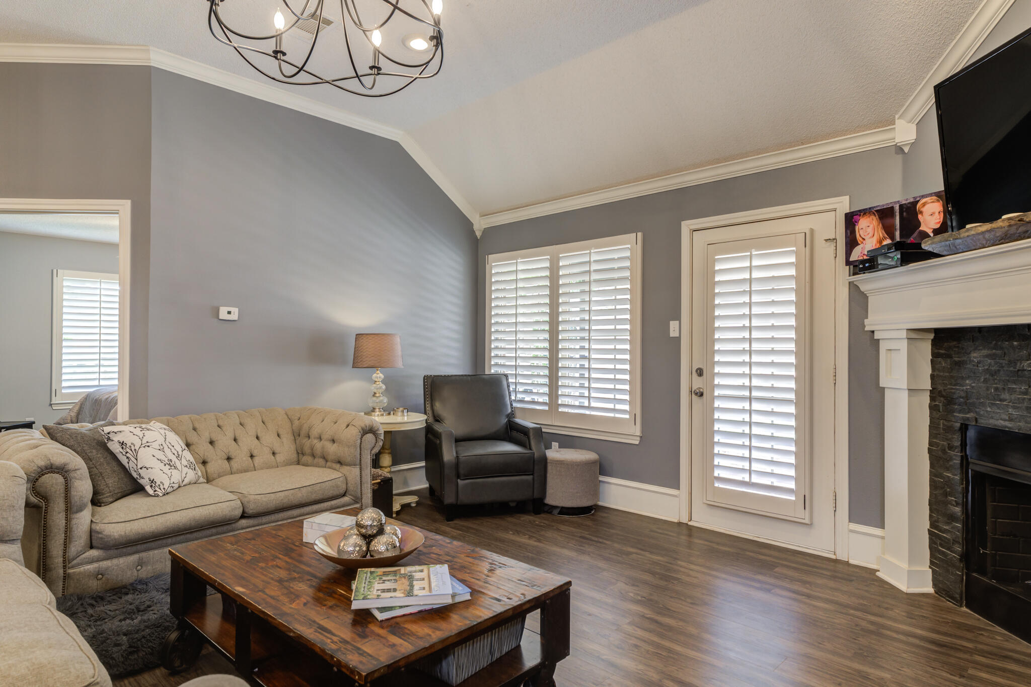 6005 83rd Street Lubbock, TX 79424 - Photo 13 of 47 a living room with furniture a fireplace and a flat screen tv