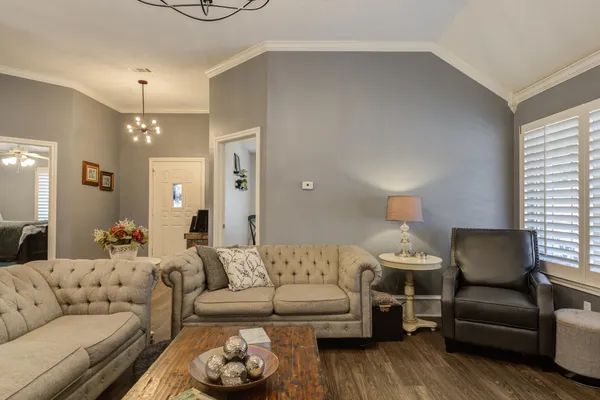 a living room with furniture a rug and a chandelier