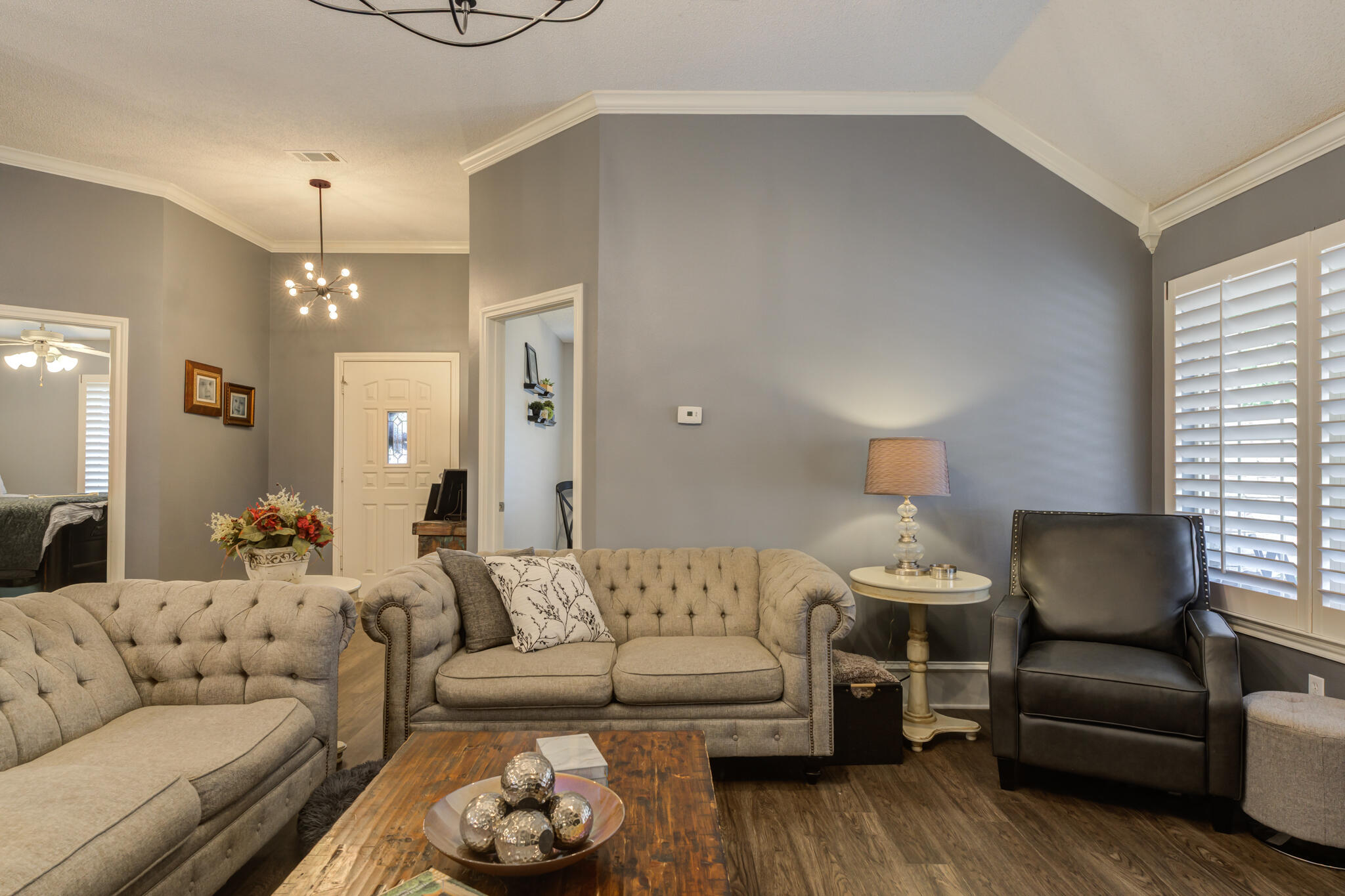 6005 83rd Street Lubbock, TX 79424 - Photo 14 of 47 a living room with furniture a rug and a chandelier