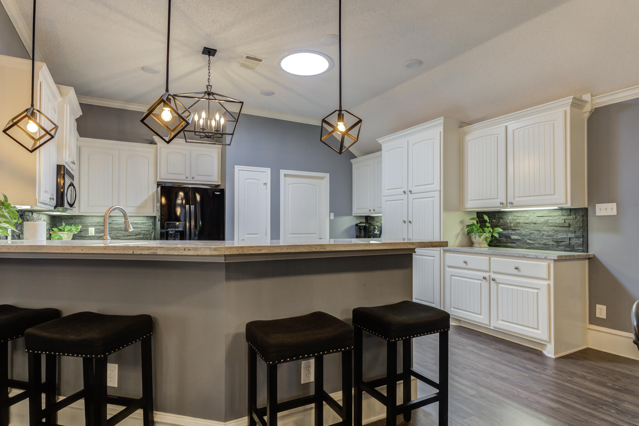 6005 83rd Street Lubbock, TX 79424 - Photo 19 of 47 a kitchen with a dining table chairs sink and cabinets