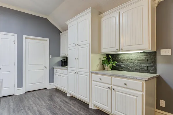 a kitchen with white cabinets and a sink