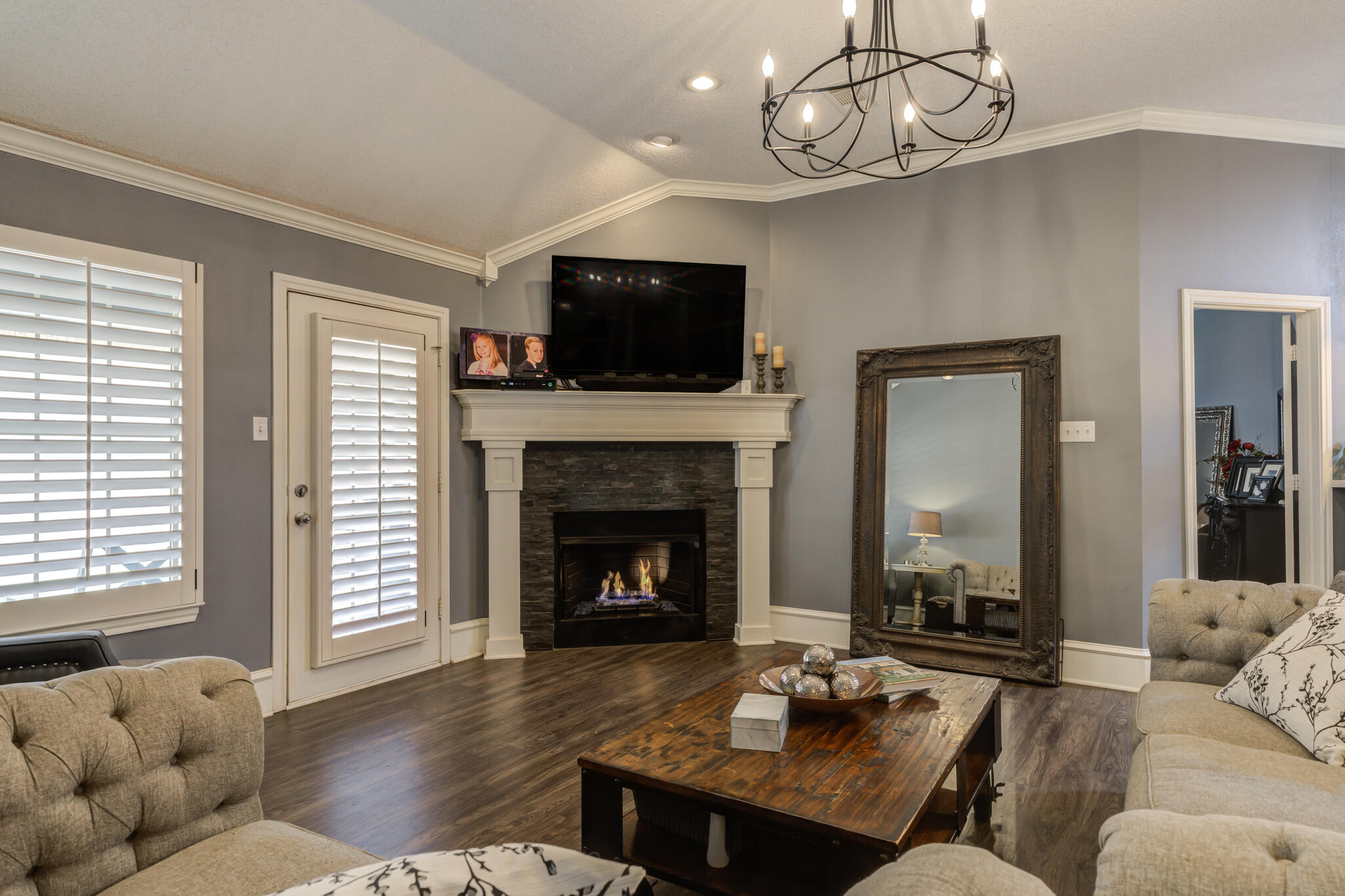 6005 83rd Street Lubbock, TX 79424 - Photo 2 of 47 a living room with furniture a flat screen tv and a fireplace