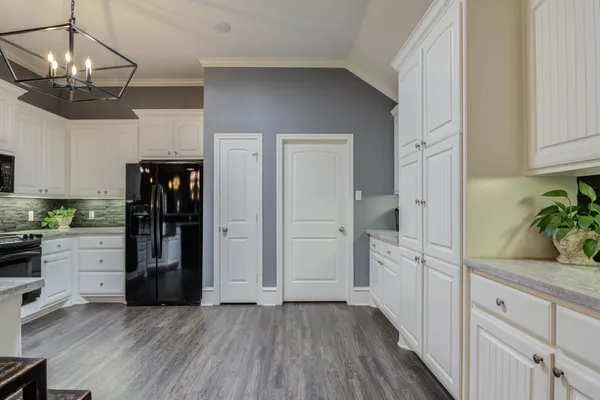 a kitchen with cabinets and stainless steel appliances