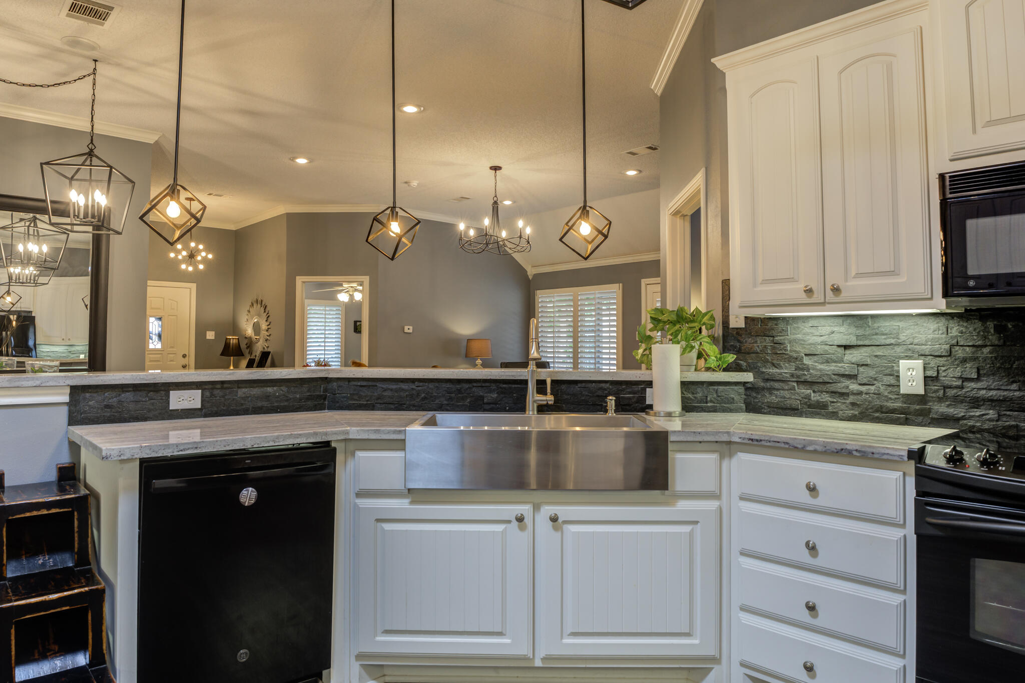 6005 83rd Street Lubbock, TX 79424 - Photo 25 of 47 a kitchen with kitchen island a counter space a sink and stainless steel appliances