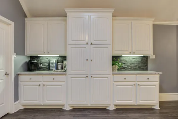 a view of white cabinets and window