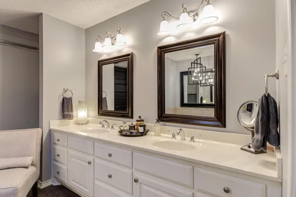 a bathroom with double vanity sinks and a mirror