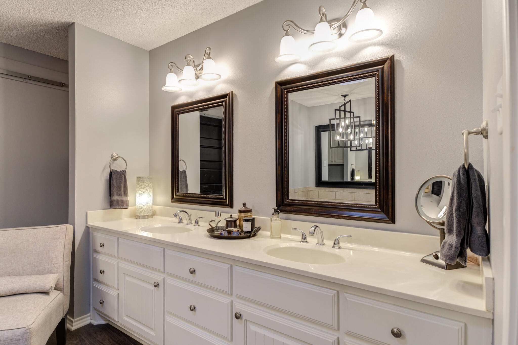 6005 83rd Street Lubbock, TX 79424 - Photo 31 of 47 a bathroom with double vanity sinks and a mirror