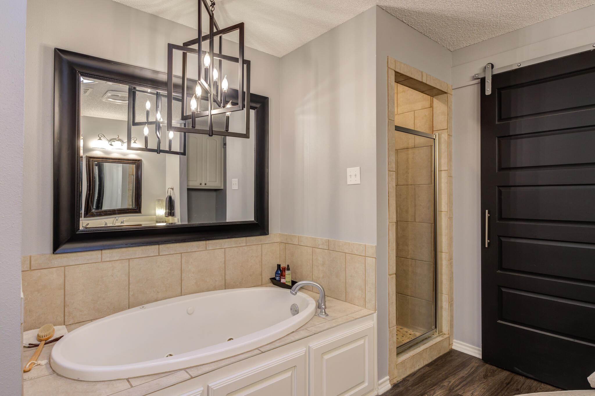6005 83rd Street Lubbock, TX 79424 - Photo 32 of 47 a bathroom with a bathtub and a shower