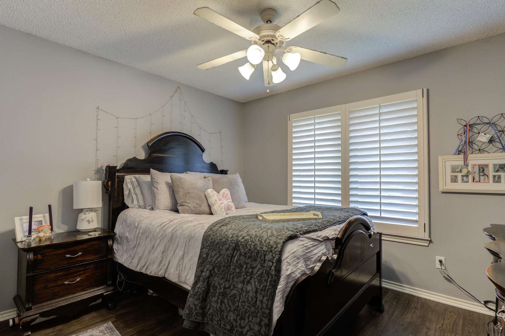 6005 83rd Street Lubbock, TX 79424 - Photo 34 of 47 a bedroom with a bed a chandelier and a window