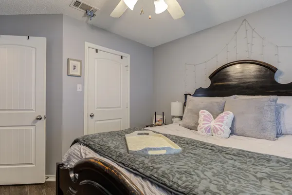 a bedroom with a bed and a chandelier