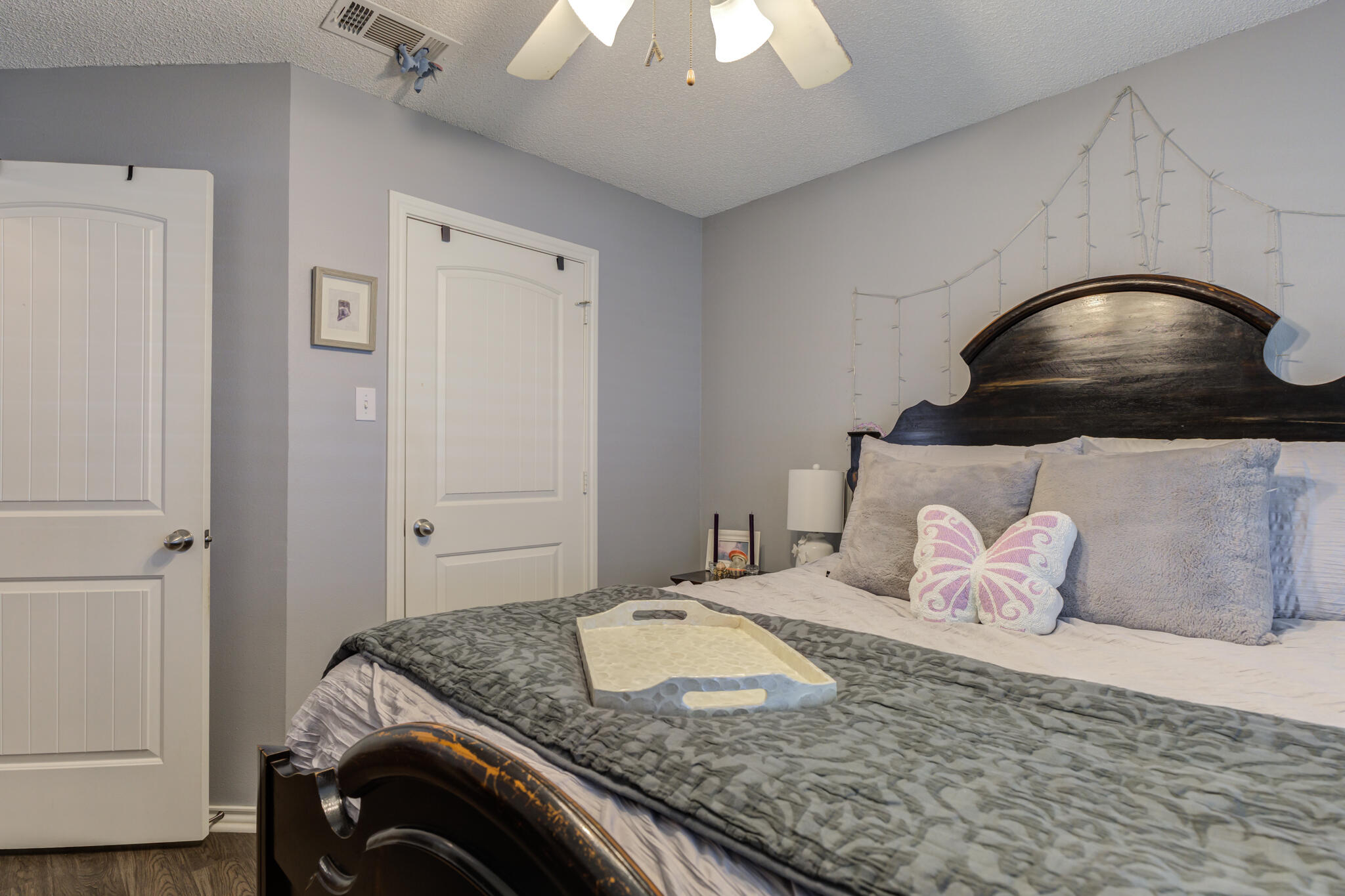 6005 83rd Street Lubbock, TX 79424 - Photo 35 of 47 a bedroom with a bed and a chandelier