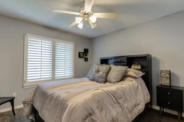 a bedroom with a large bed and a chandelier