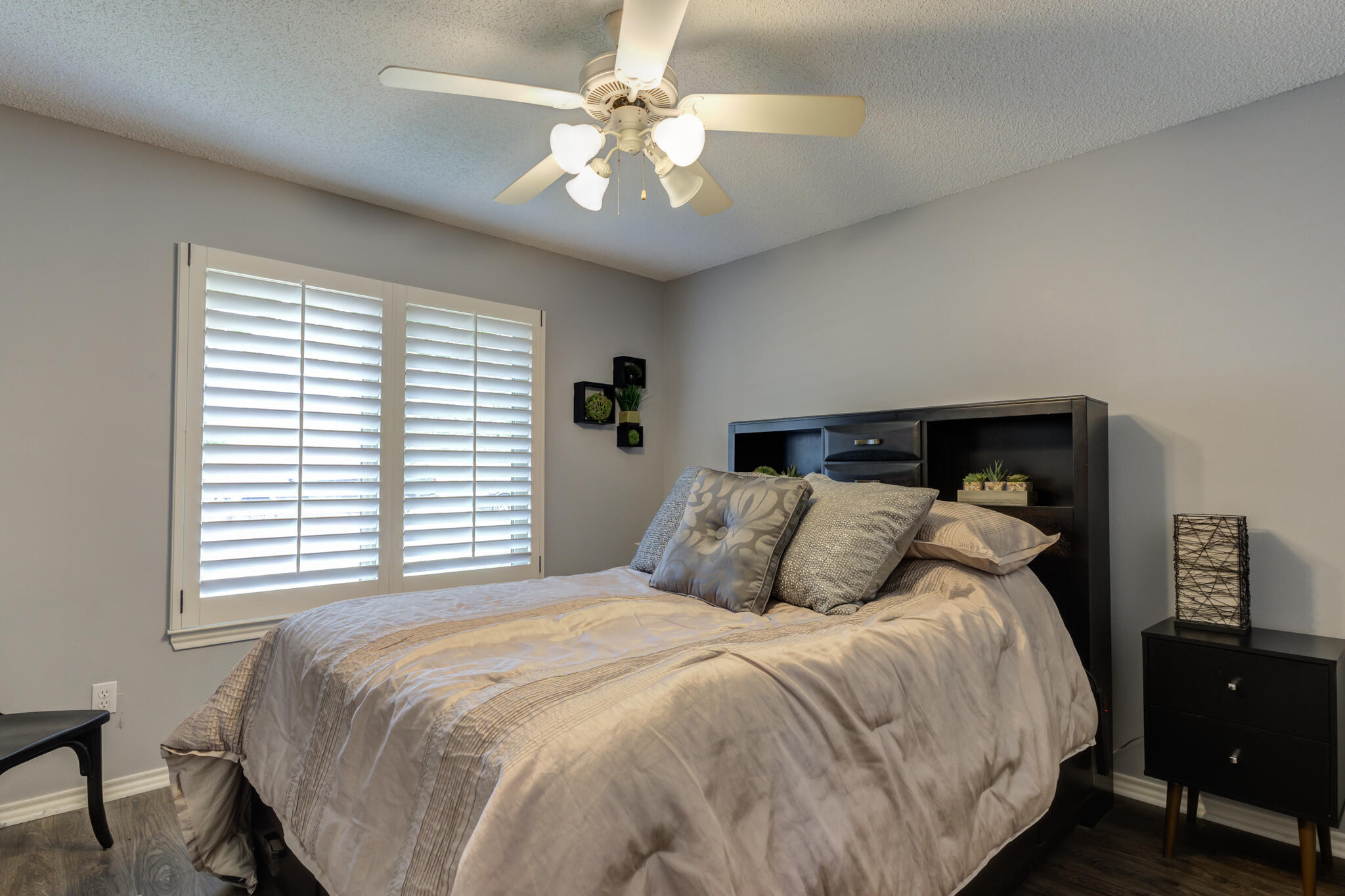 6005 83rd Street Lubbock, TX 79424 - Photo 36 of 47 a bedroom with a large bed and a chandelier