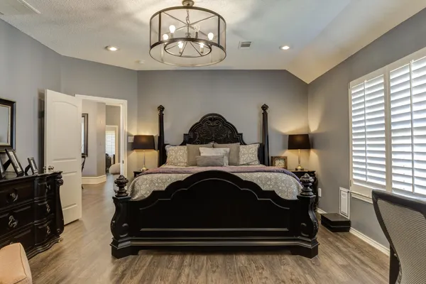 a bedroom with a bed and dresser