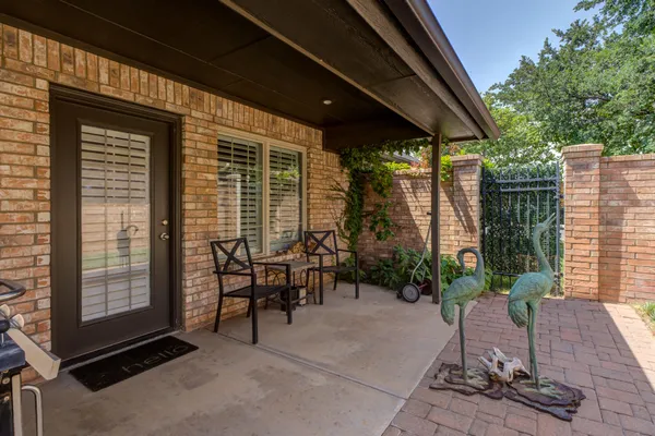 a view of a patio with table and chairs and potted plants
