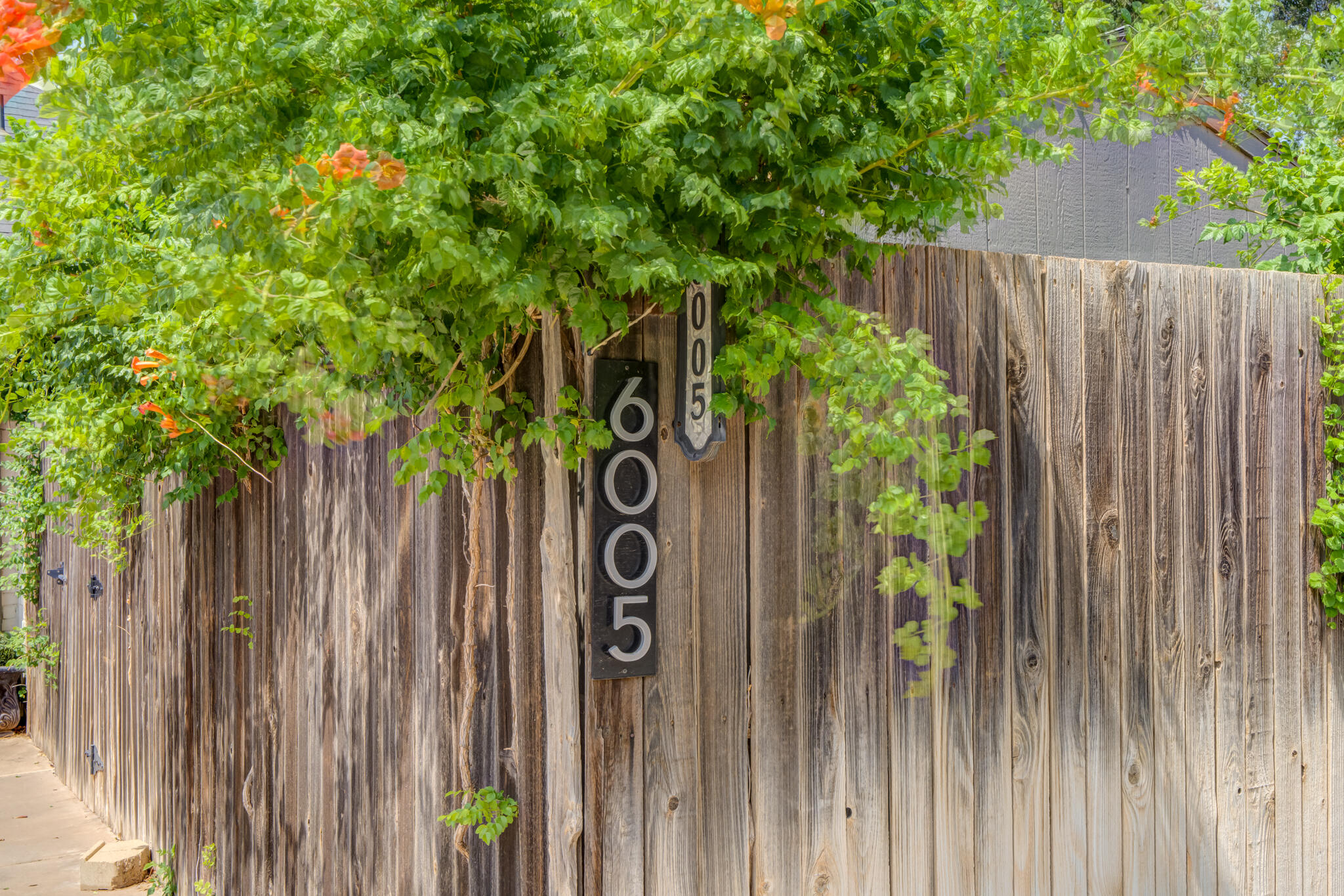 6005 83rd Street Lubbock, TX 79424 - Photo 46 of 47 a sign that is on the wooden fence