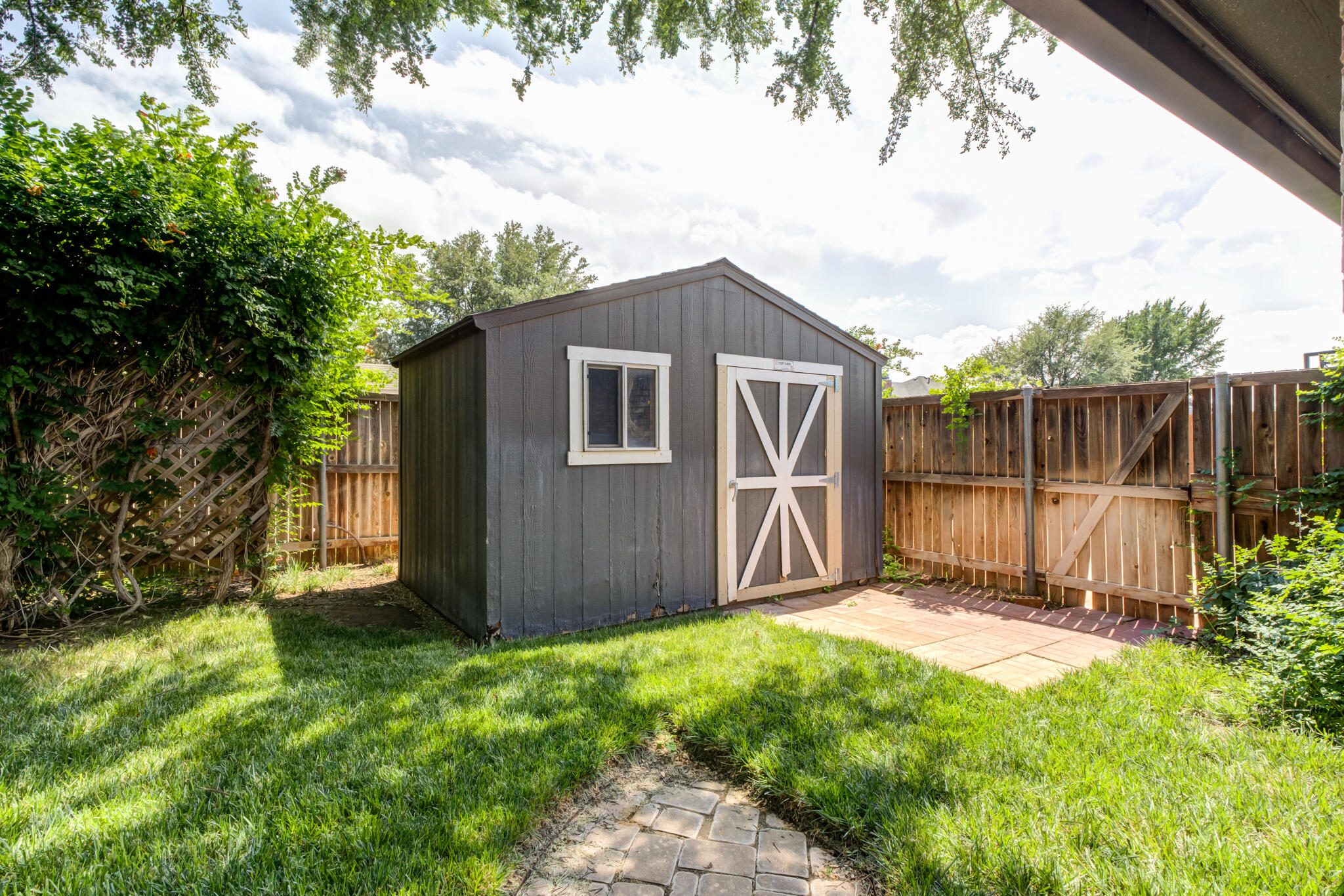 6005 83rd Street Lubbock, TX 79424 - Photo 5 of 47 a view of backyard with garden and tall trees