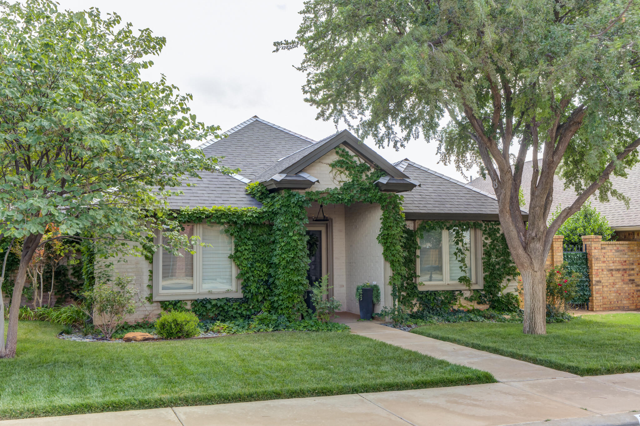 6005 83rd Street Lubbock, TX 79424 - Photo 6 of 47 a front view of a house with a yard