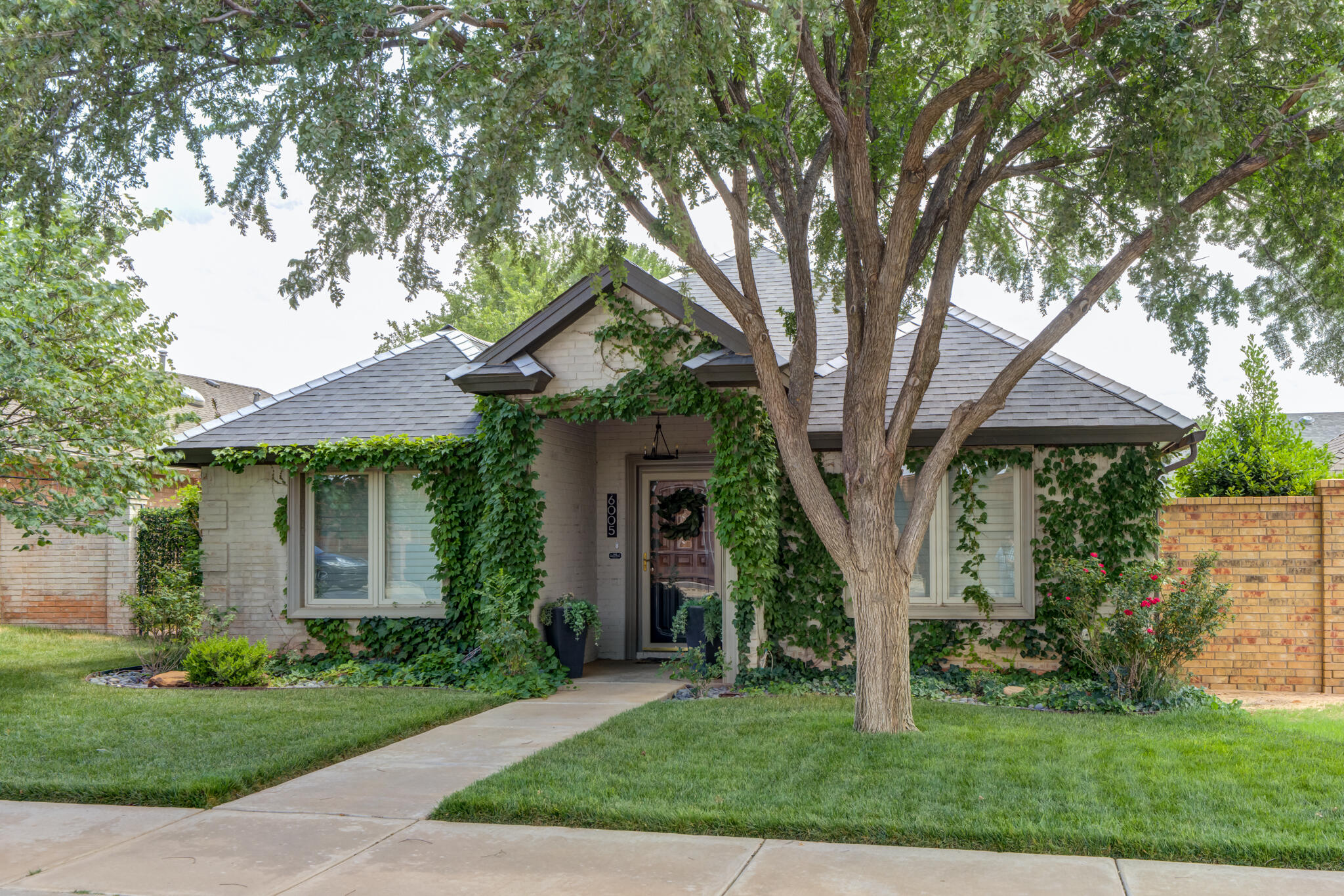6005 83rd Street Lubbock, TX 79424 - Photo 7 of 47 a front view of a house with a garden