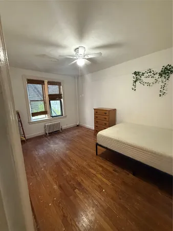 an empty room with windows and ceiling fan