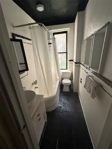 a view of living room with furniture and a window