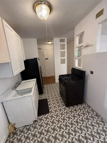 a kitchen with a sink and a refrigerator