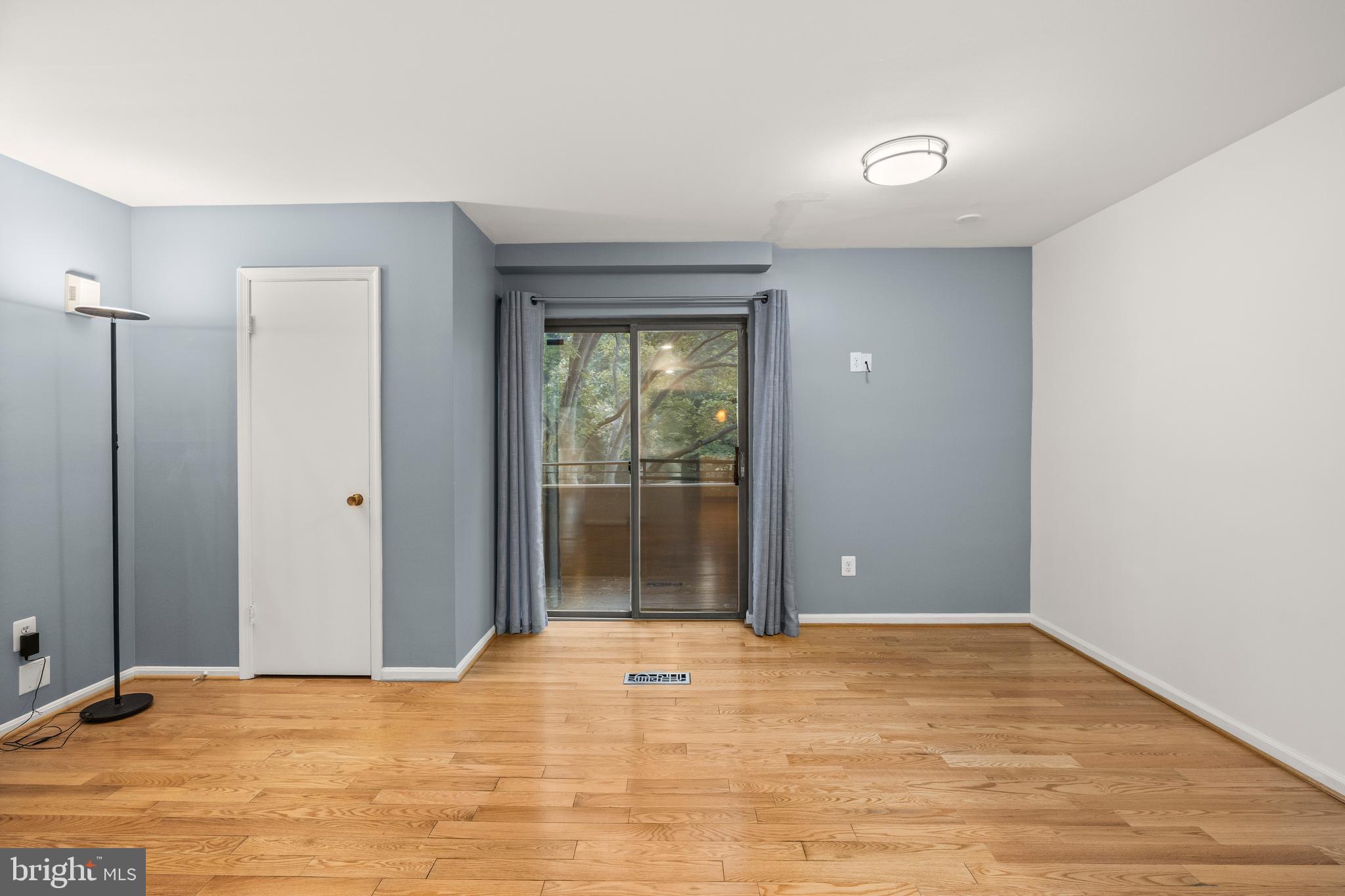 11110 Saffold Way Reston, VA 20190 - Photo 18 of 57 a view of an empty room with wooden floor and a window