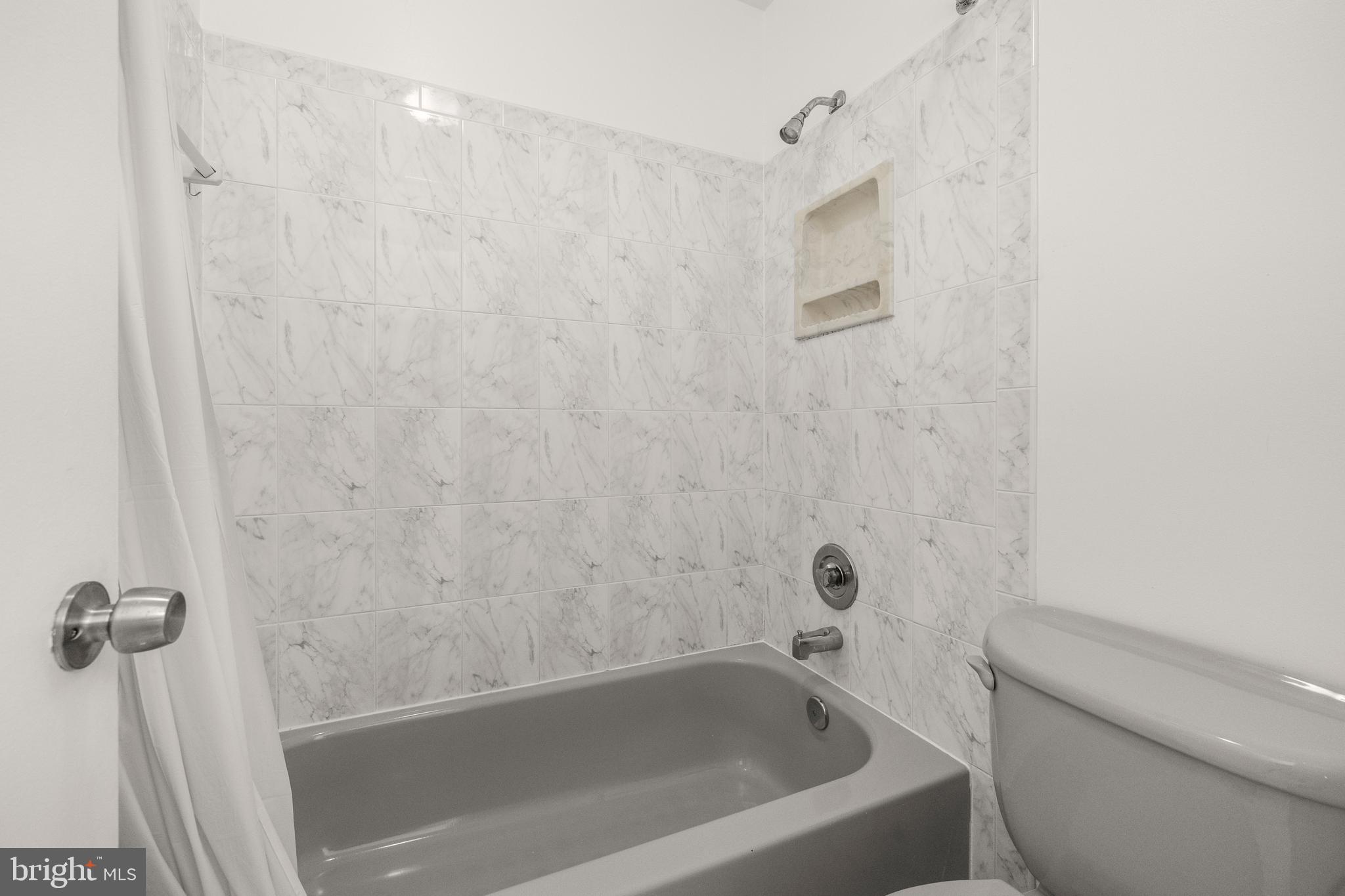 11110 Saffold Way Reston, VA 20190 - Photo 26 of 57 a bathroom with a bathtub