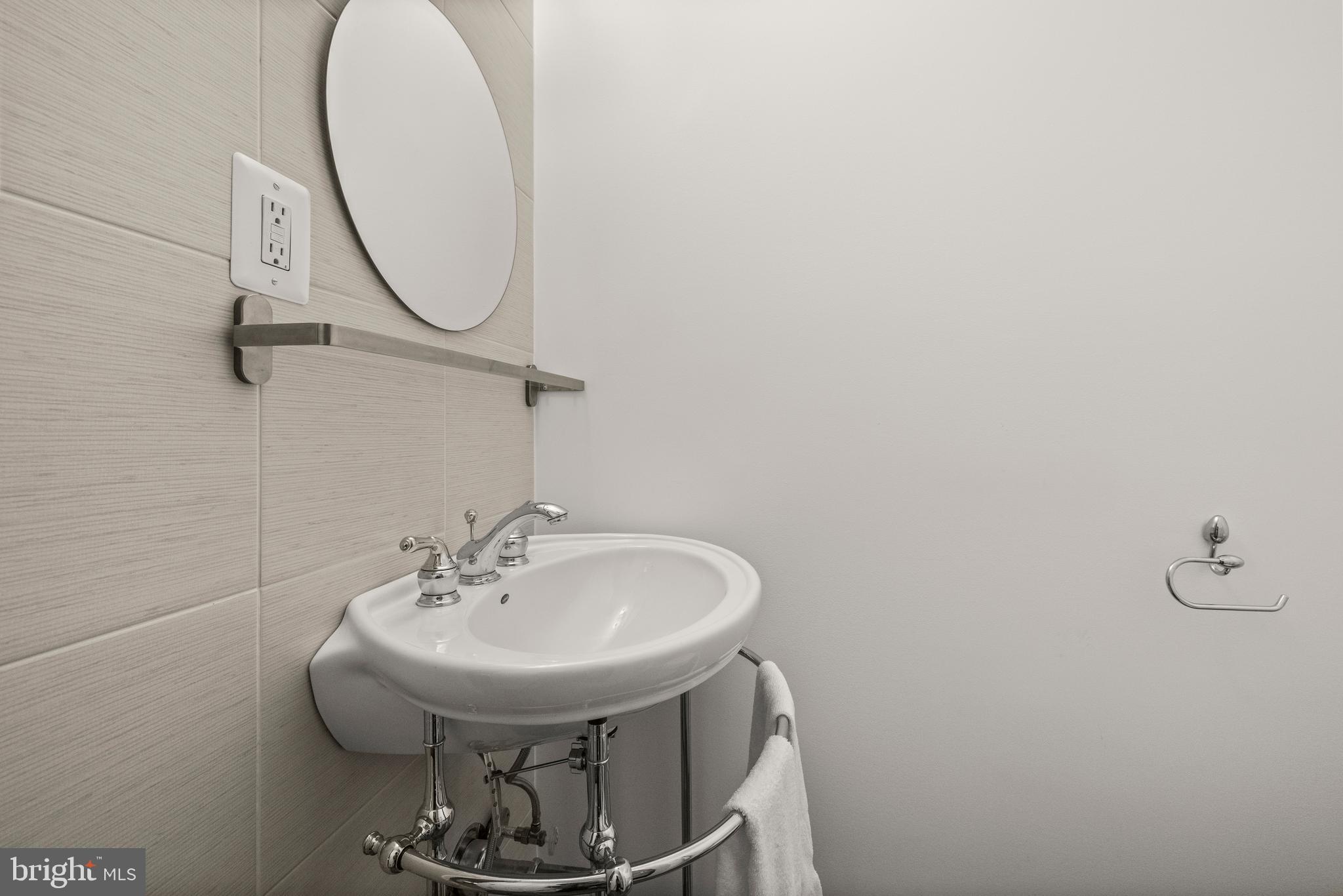 11110 Saffold Way Reston, VA 20190 - Photo 29 of 57 a bathroom with a sink and a mirror