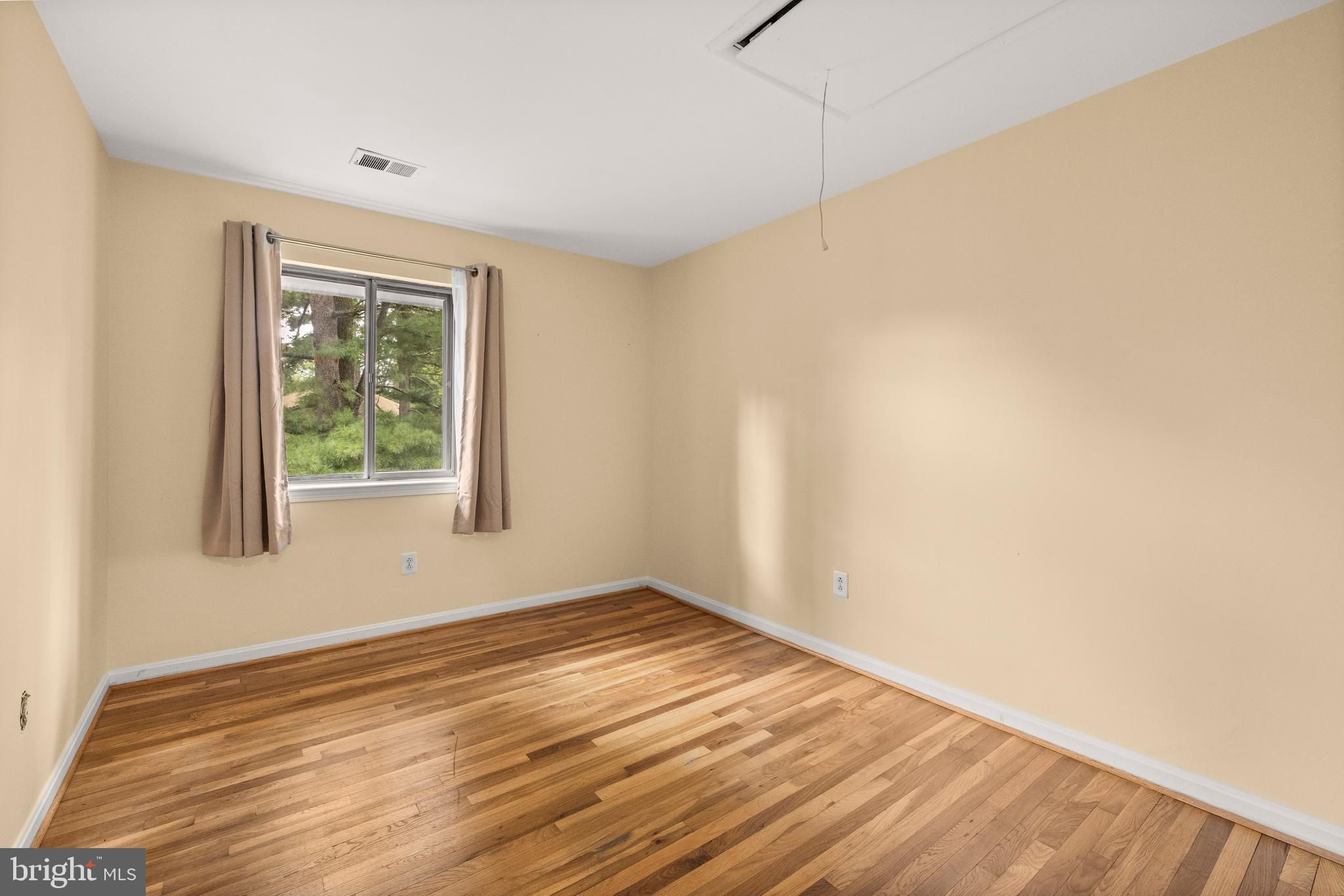 11110 Saffold Way Reston, VA 20190 - Photo 30 of 57 a view of an empty room with wooden floor and a window