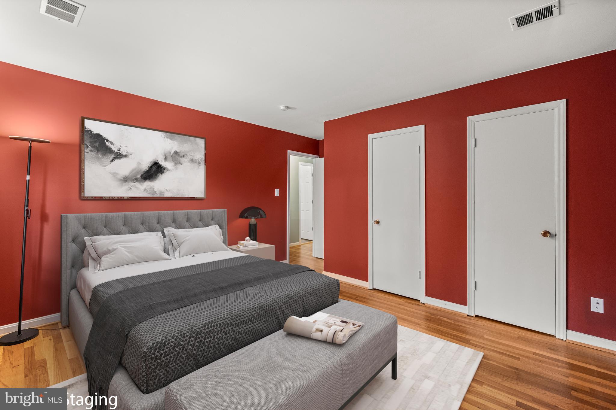 11110 Saffold Way Reston, VA 20190 - Photo 32 of 57 a bedroom with a bed and a painting on the wall