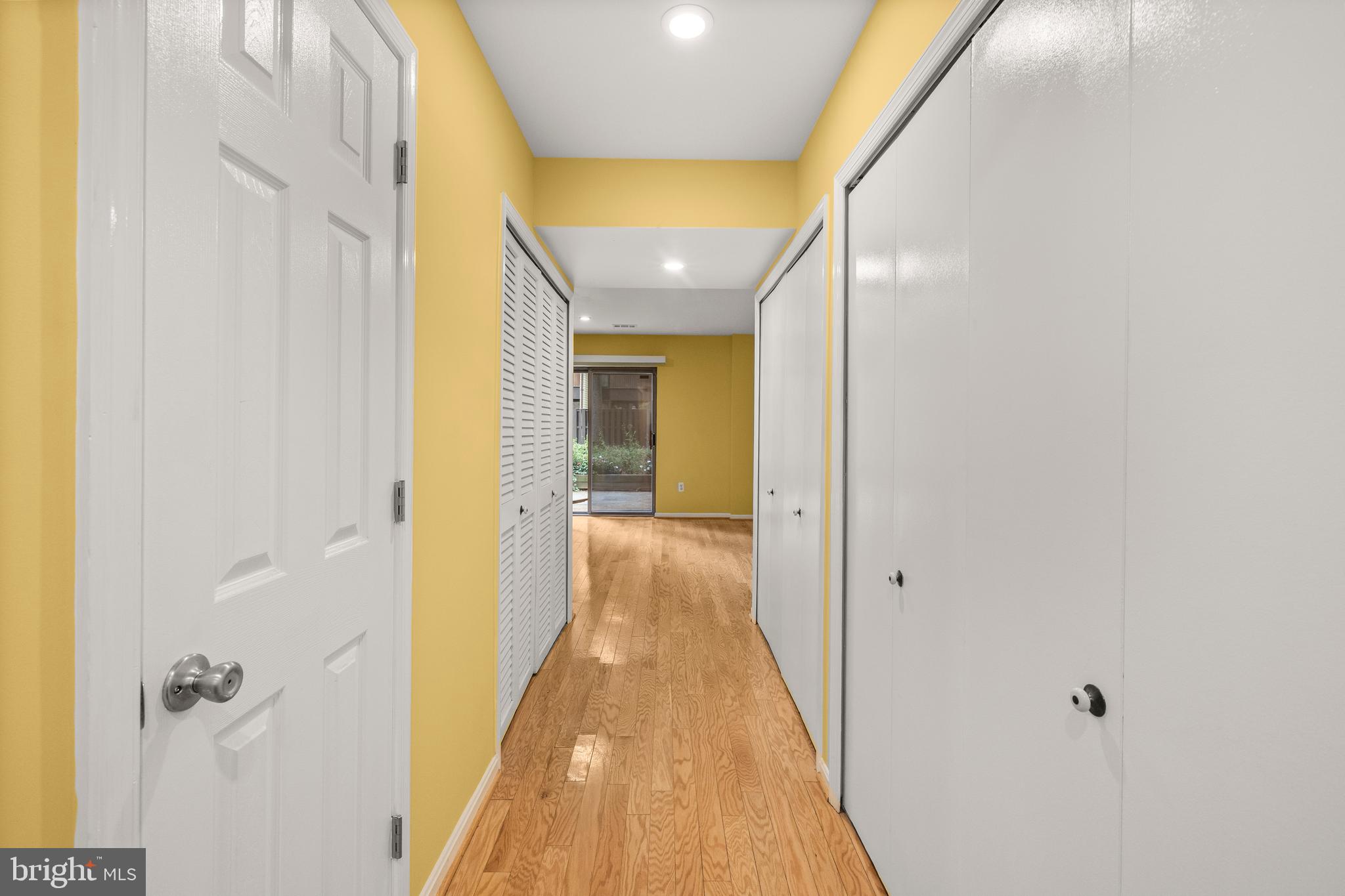 11110 Saffold Way Reston, VA 20190 - Photo 35 of 57 a view of a hallway with wooden floor and a bathroom