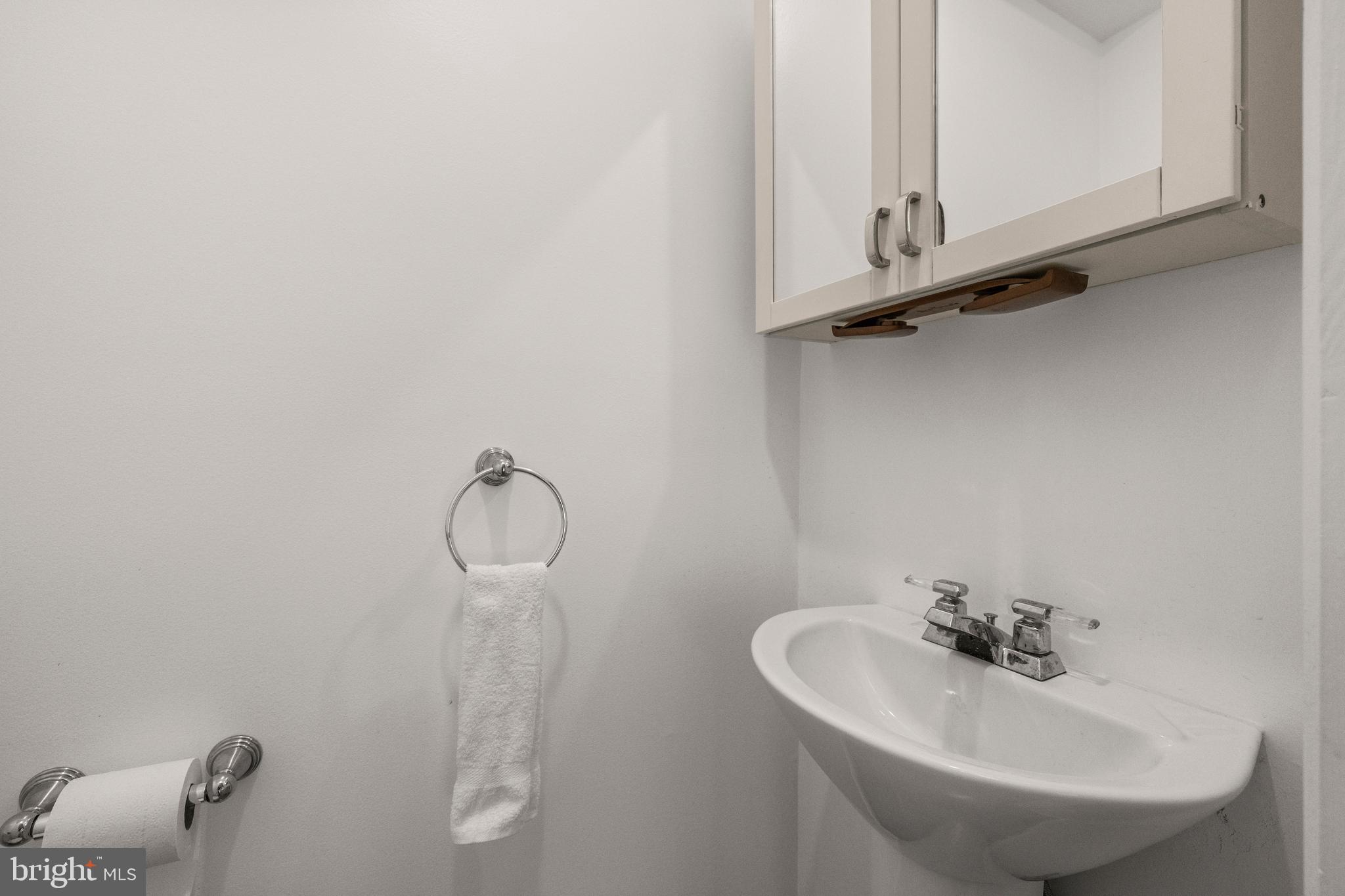 11110 Saffold Way Reston, VA 20190 - Photo 49 of 57 a bathroom with a sink and mirror