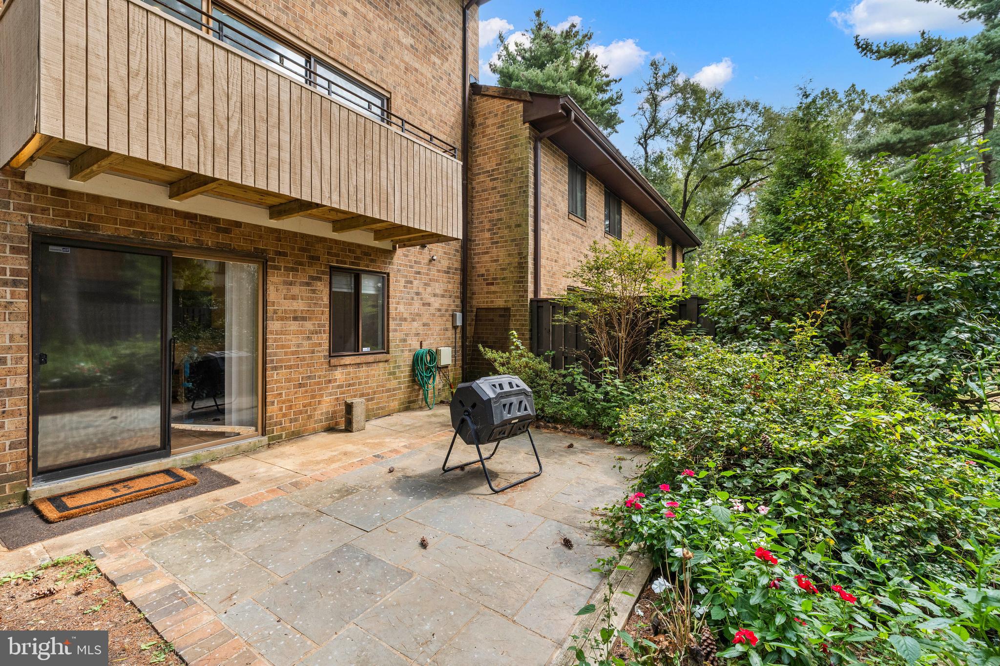 11110 Saffold Way Reston, VA 20190 - Photo 52 of 57 a view of a chair and tables in the patio with a house
