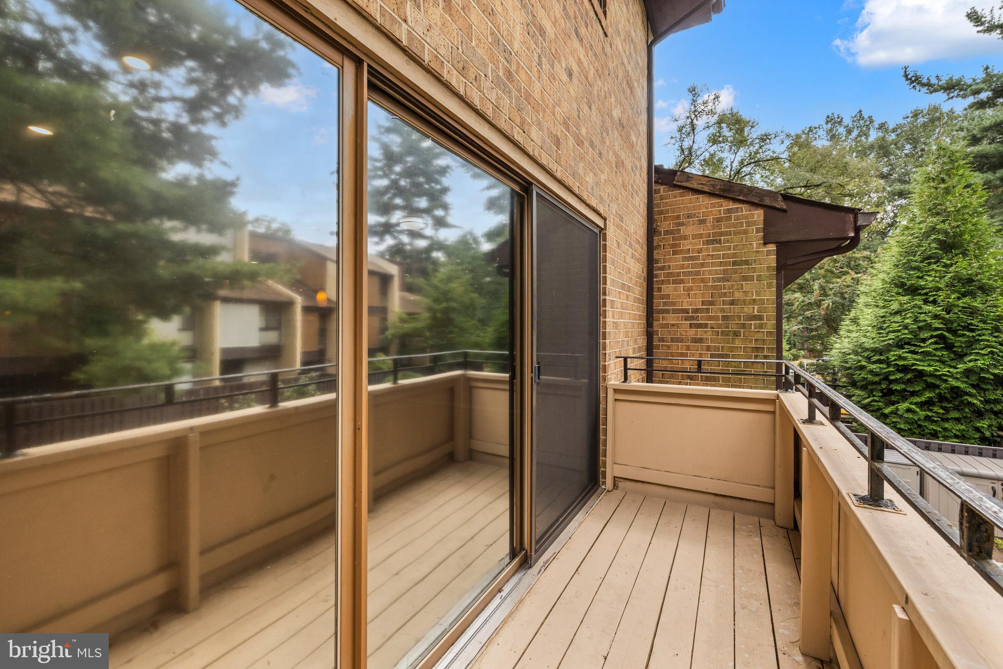 11110 Saffold Way Reston, VA 20190 - Photo 6 of 57 a view of a balcony with wooden floor and fence