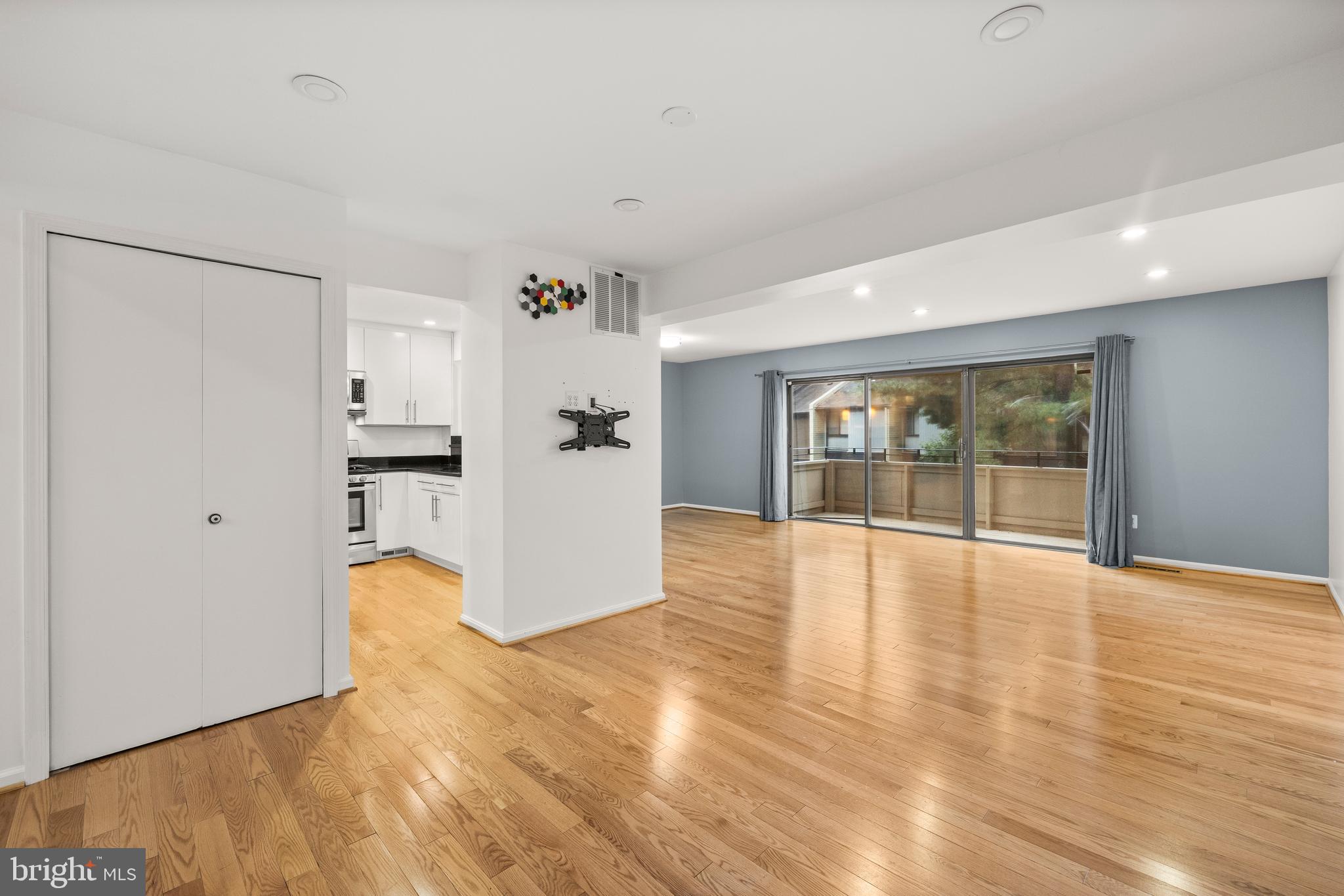 11110 Saffold Way Reston, VA 20190 - Photo 9 of 57 a view of an empty room with wooden floor and a window