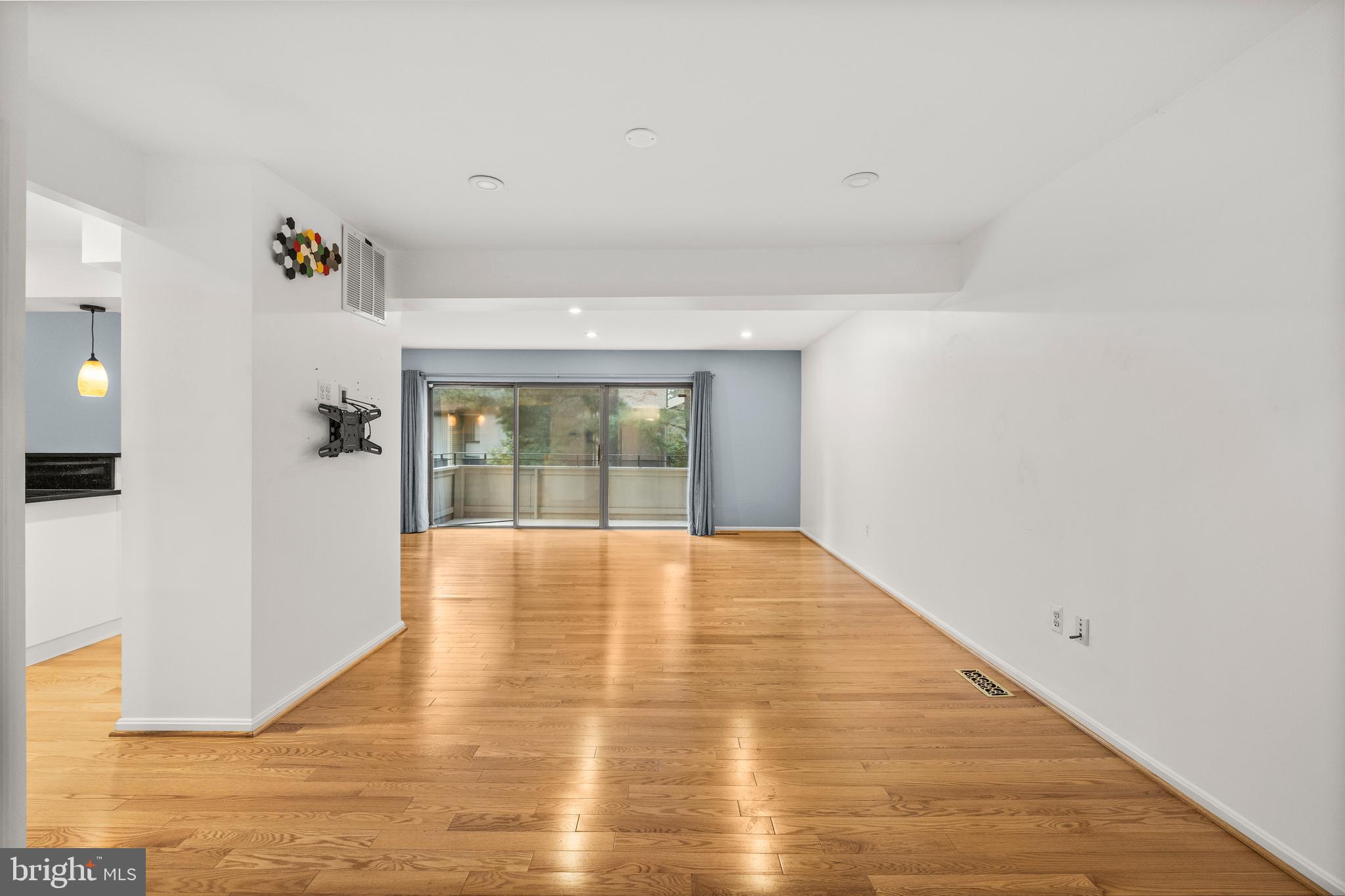 11110 Saffold Way Reston, VA 20190 - Photo 10 of 57 a view of an empty room with wooden floor and a window