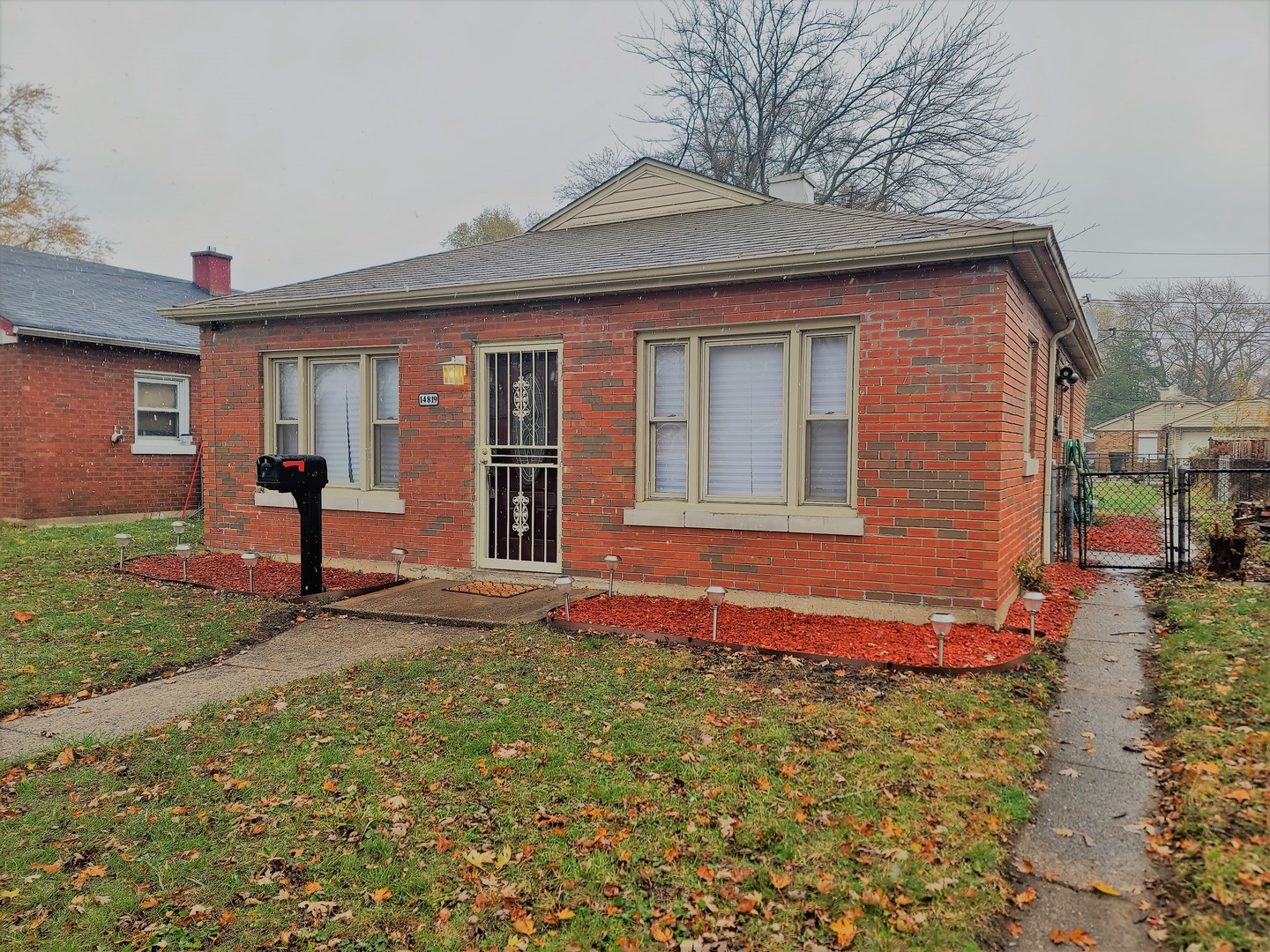 14819 Champlain Street Dolton, IL 60419 - Photo 1 of 1 a front view of a house with garden
