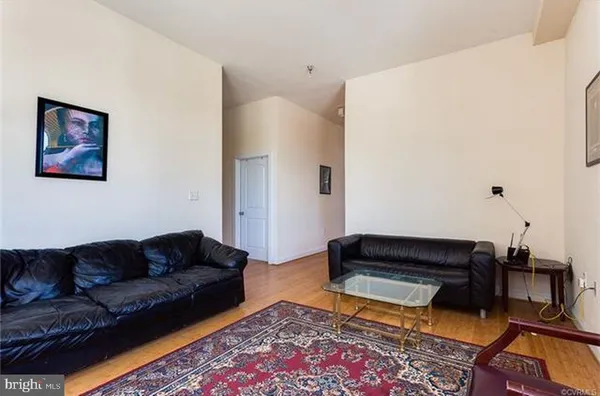 a living room with furniture and a rug