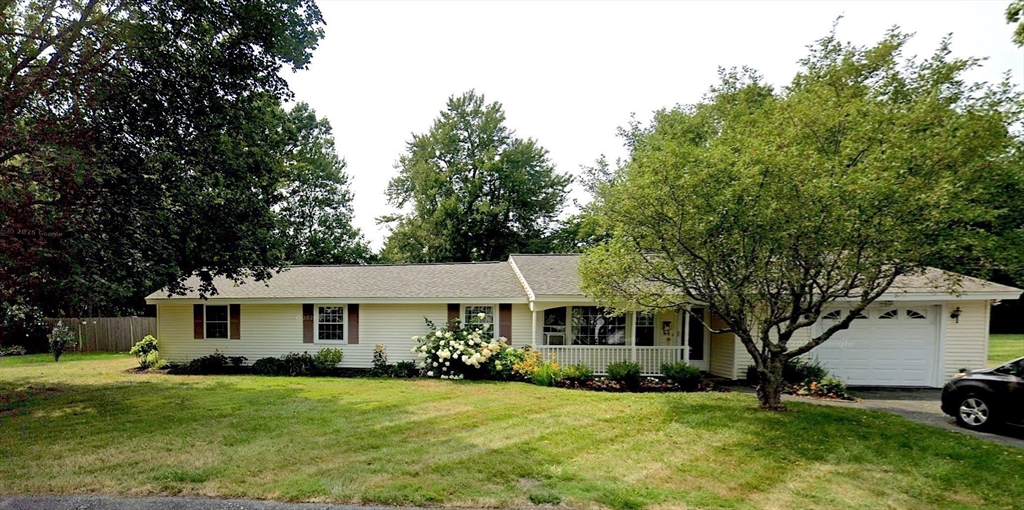 a front view of a house with a garden